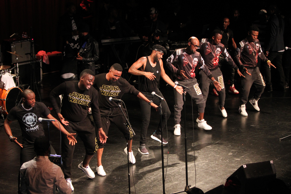A Congolese band and dancers performing on stage during a live-music evening of the kind featured on a Kinshasa night out.
