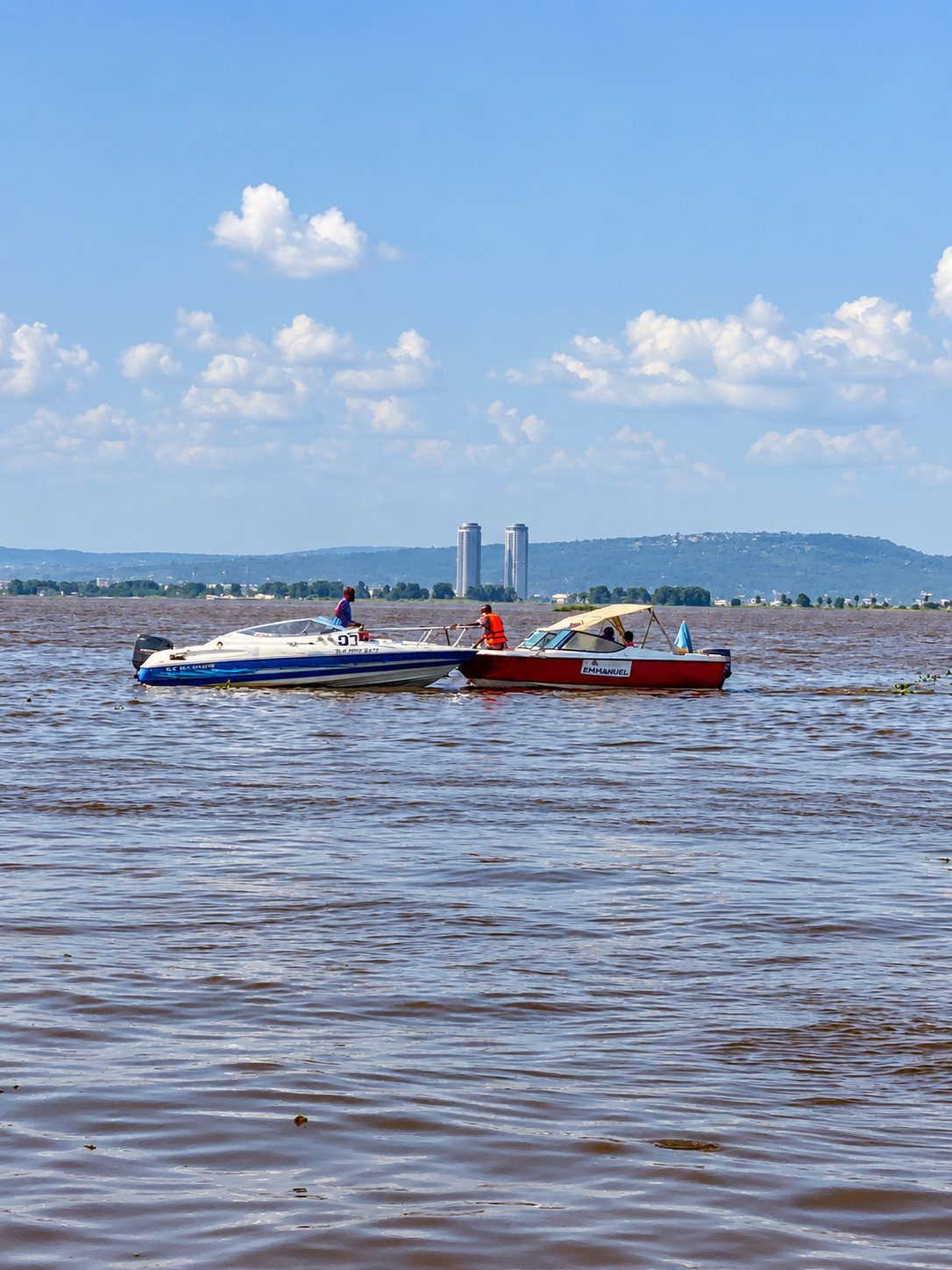 The Congo River seen from a cruise boat, with islands and shoreline in view.