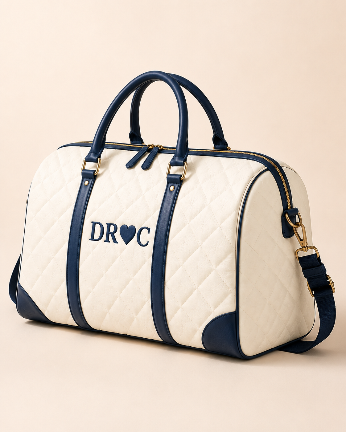 DRCTOURISM quilted cream duffle bag with navy leather trim, gold hardware and the DR♥C emblem