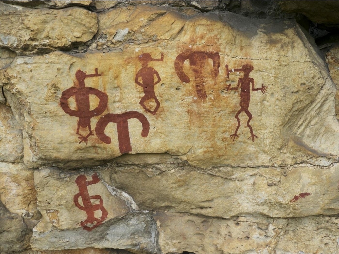 Rock art figures painted on a cave wall in the Lovo Massif