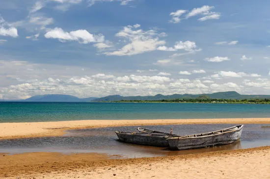 Pristine Kibige Island on Lake Tanganyika with traditional canoes