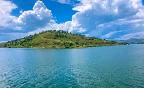 Lake Albert shores with green hills and blue waters on the DRC-Uganda border