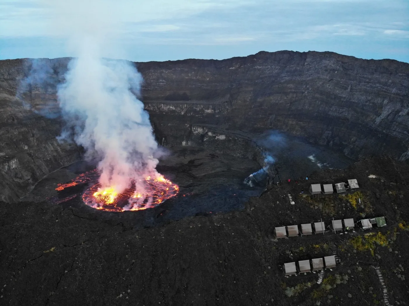 Aerial view of Mount Nyiragongo's active lava lake and crater rim camp, Virunga National Park, DRC