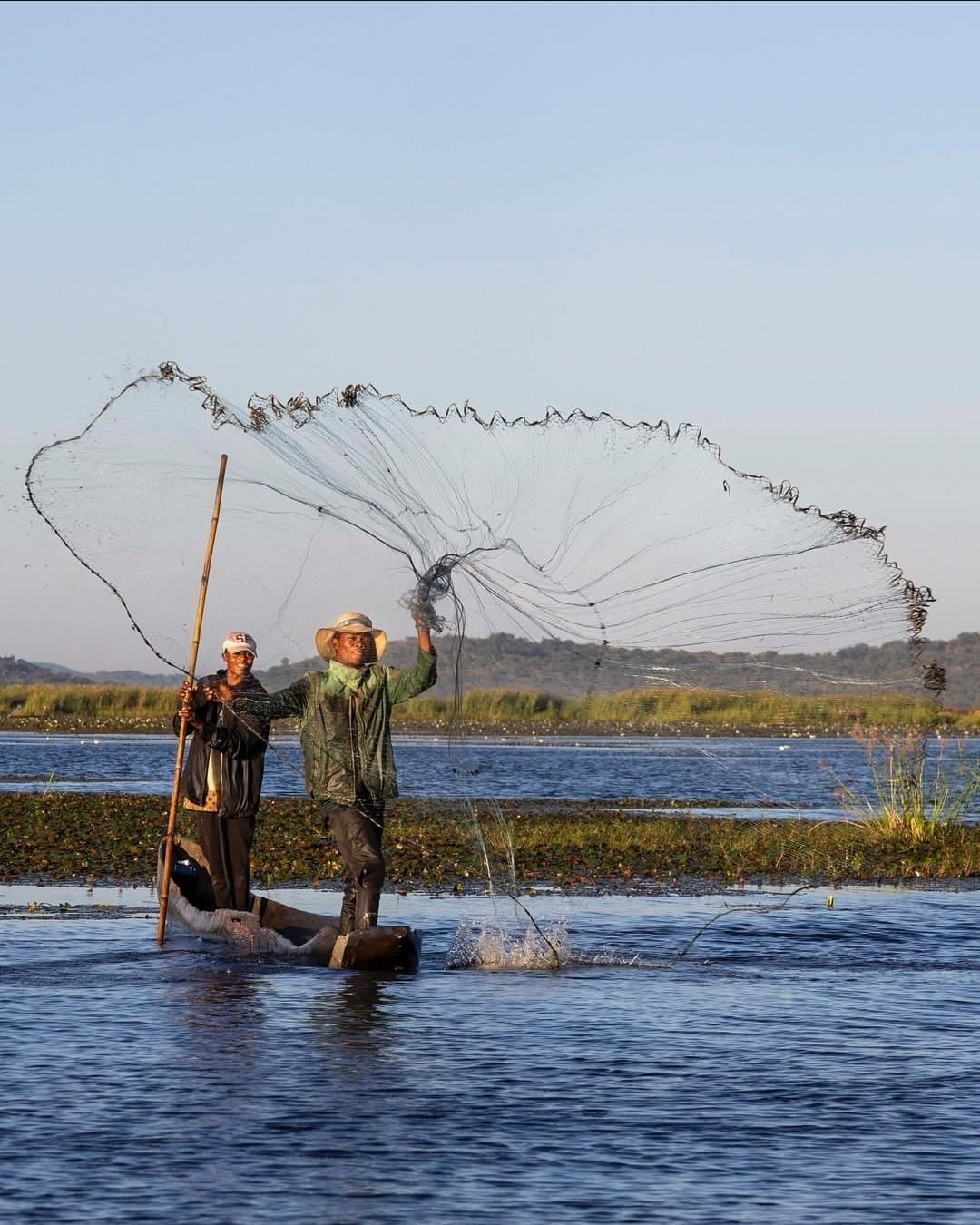 Fishermen casting nets in Upemba lakes